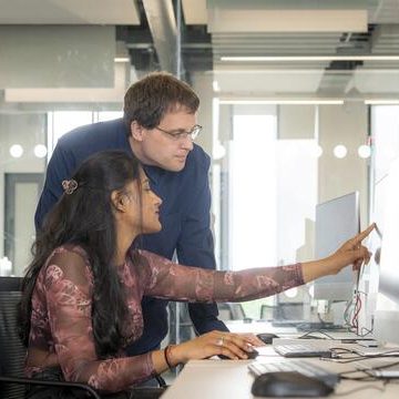 Two people looking at a computer